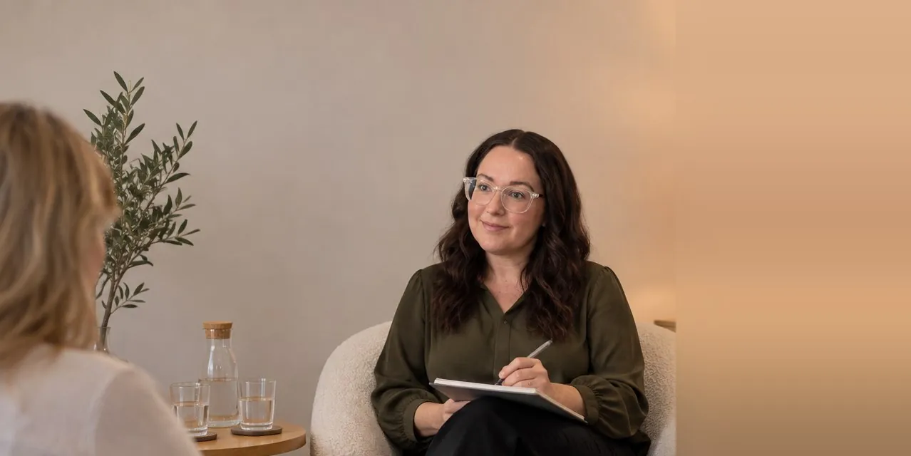 Karly O’Shea in a session with a client, listening and taking notes
